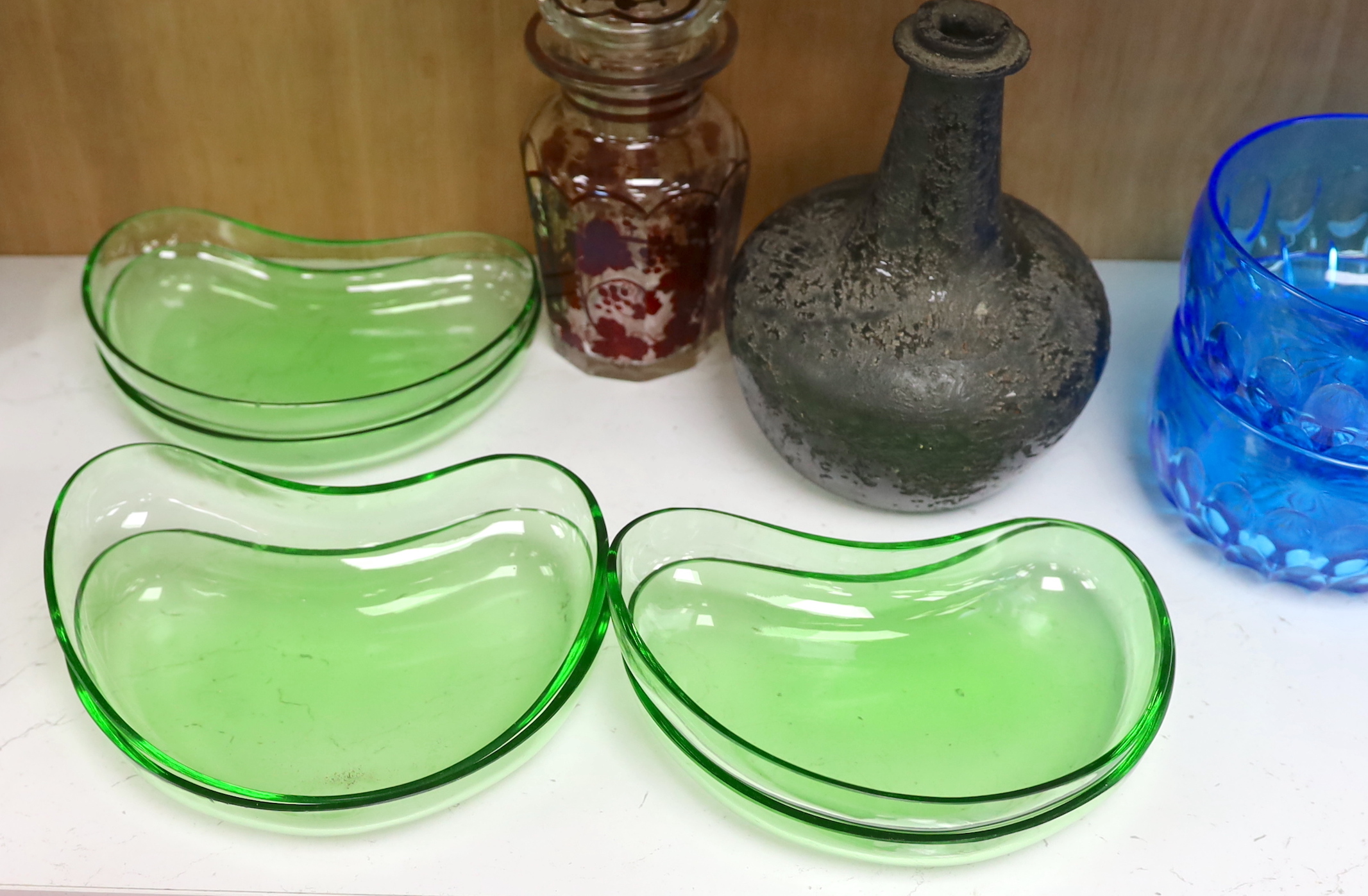 Assorted glassware including an 18th century Dutch onion shaped wine bottle, a set of six blue glass finger bowls and a Bohemian style decanter and stopper, largest 18cm high